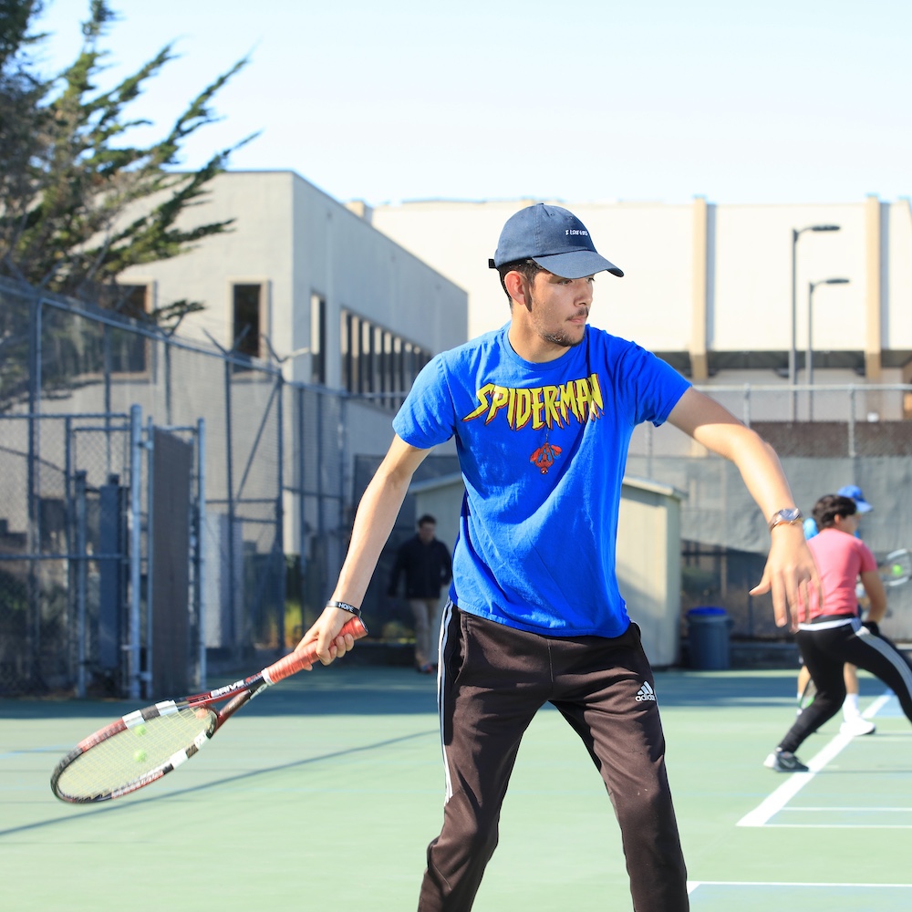 MPC Student About to Hit Tennis Ball on Campus Tennis Court