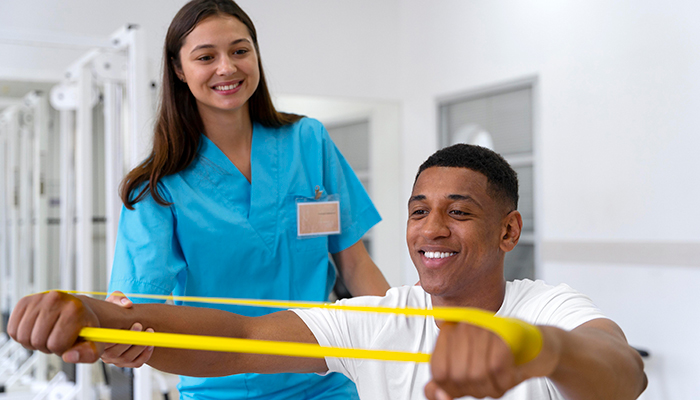 Therapist helping patient with physiotherapy exercises