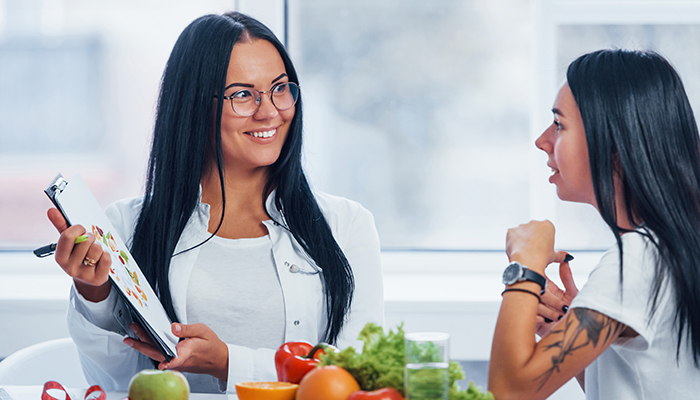 Dietician explains the food pyramid to a student