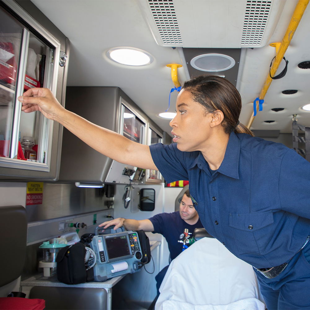 EMT gets supplies from within an ambulance