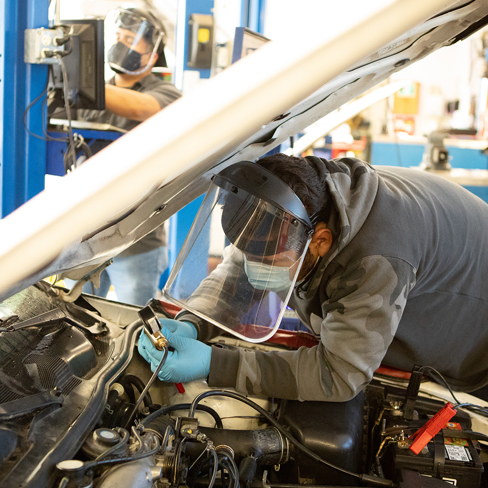 MPC Auto Tech student working on a car during class