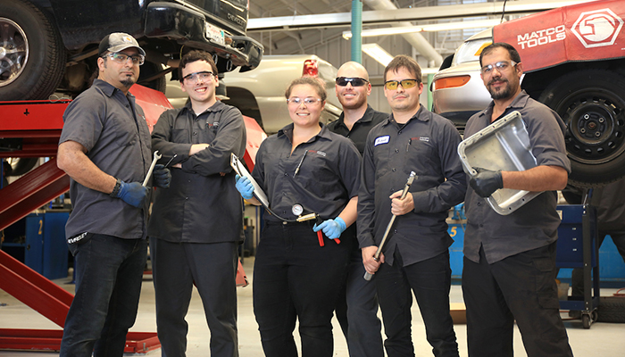 Hero shot of MPC Auto Tech students in garage