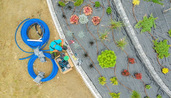 Irrigation specialist sets up irrigation system in a new garden