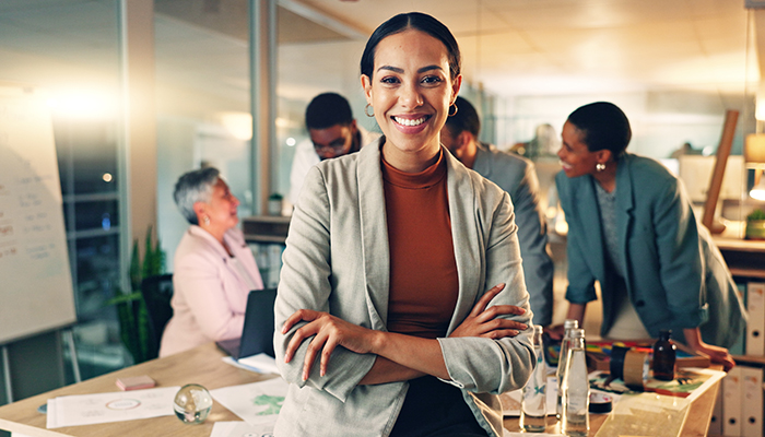 Confident business owner poses in her marketing office