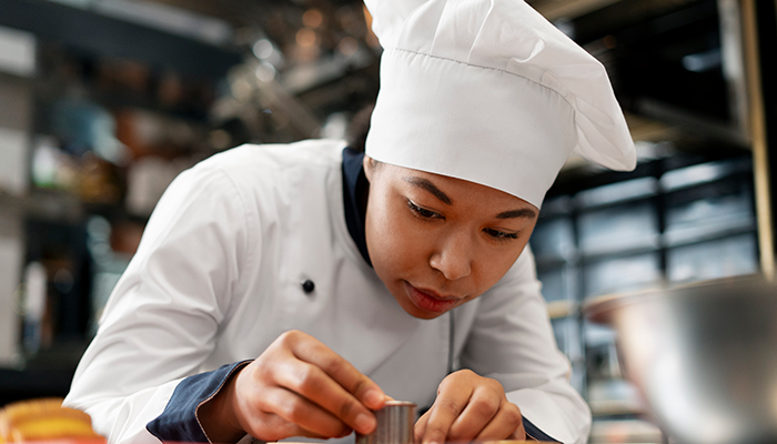 Pastry chef cuts dough with metal form