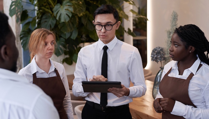 Restaurant manager working with waiting staff