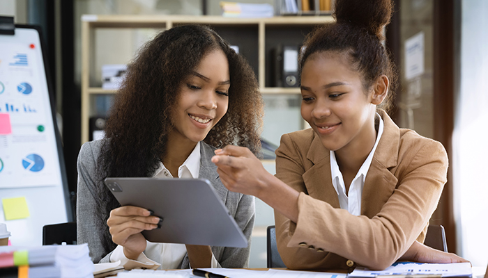 Sales associates reviewing media in an office environment