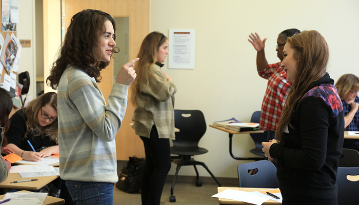 MC ASL students converse with partners in sign language during class