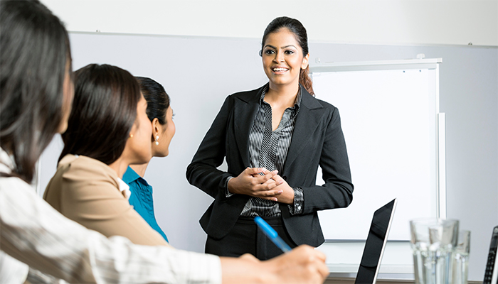 Confident business woman presenting to staff