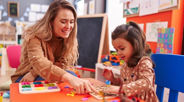 ECE Teacher Working with Young Child