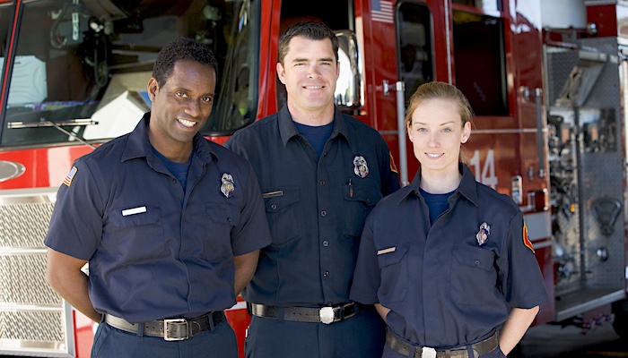 Three Firefighters Posing for Picture in Front of Firetruck