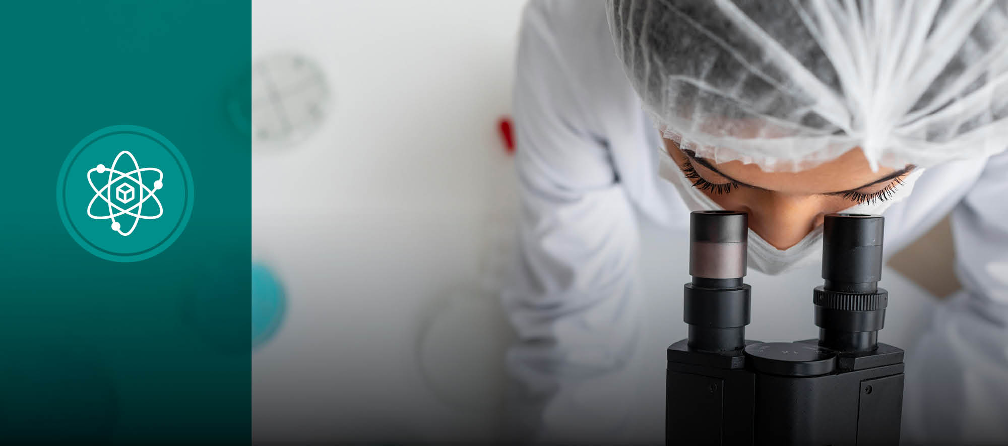 female scientist looking through microscope