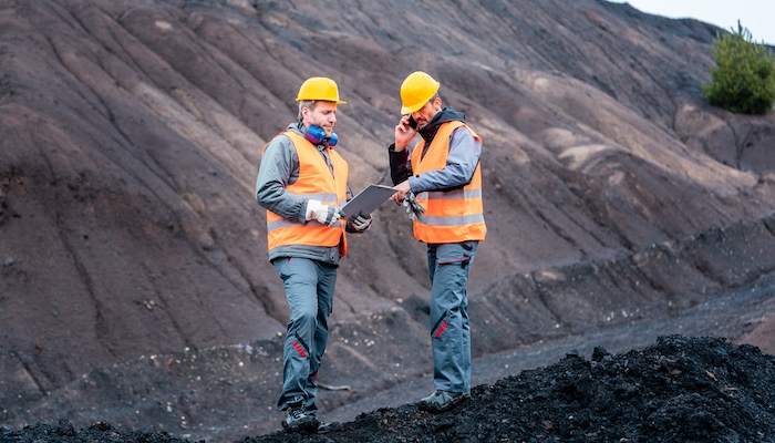 Two Geologists Discussing Outdoors with Clipboard