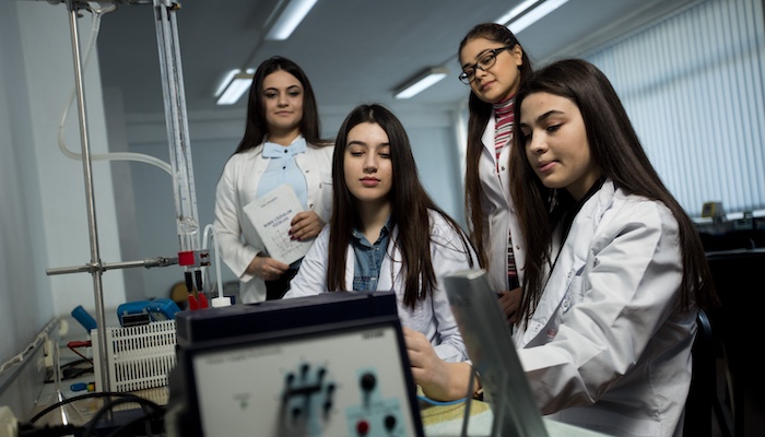 Group of Physics Students in Class Working Together