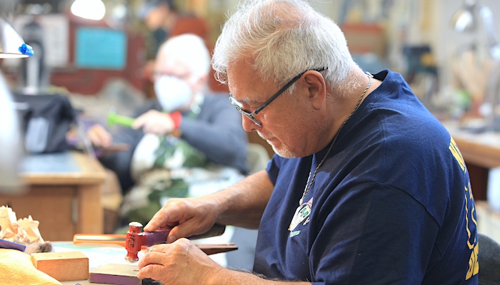 Jewelry & Metal Arts Student Hammering in Class