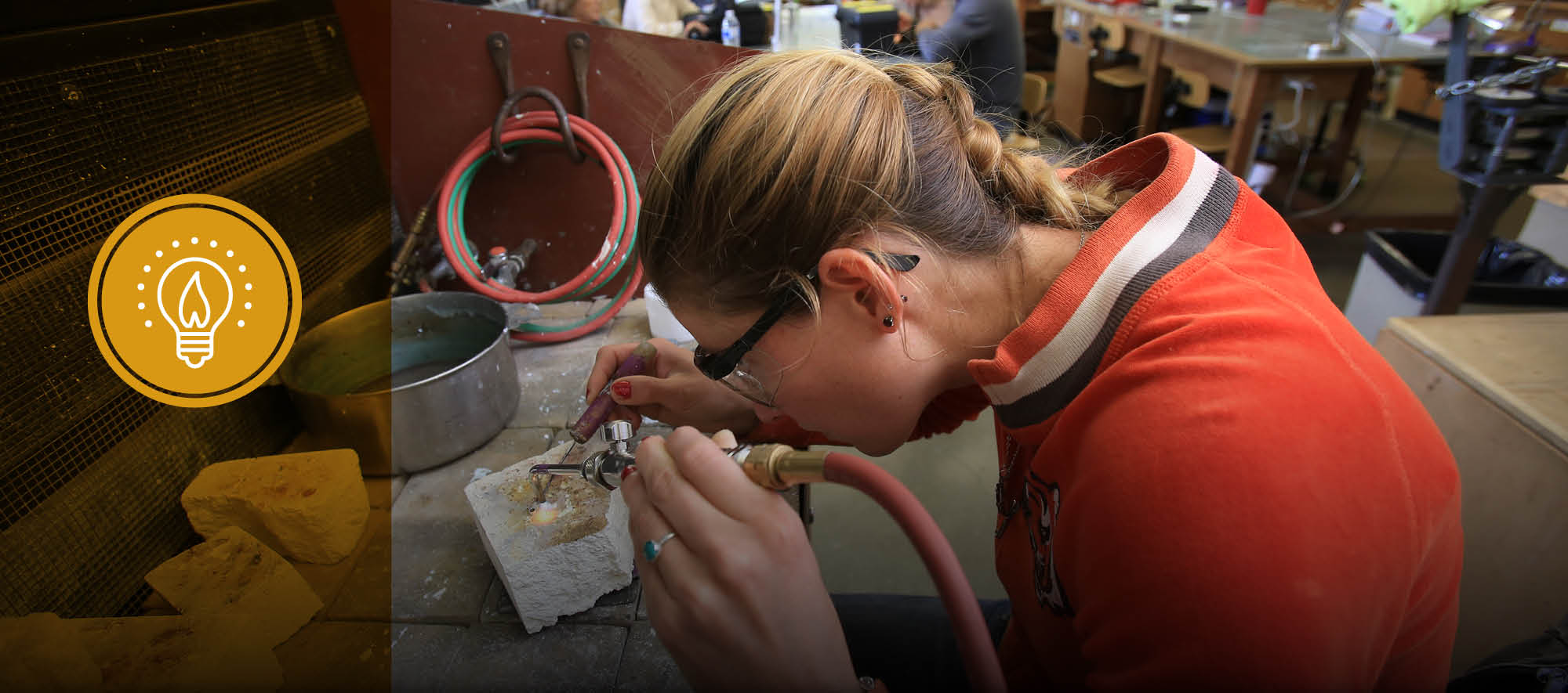 MPC jewelry student solders piece in class