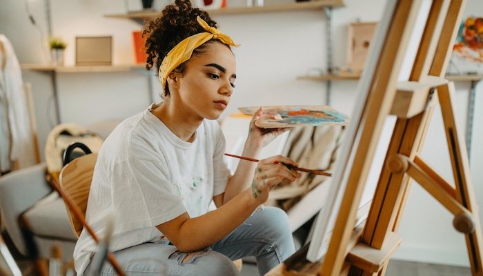 Woman Painting on Easel in Studio