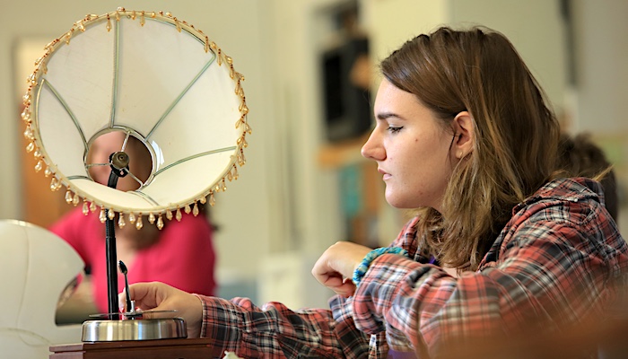 MPC Student Adjusting Lamp Sculpture in Class