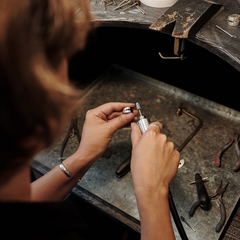 Artist Using Equipment to Buff Jewelry