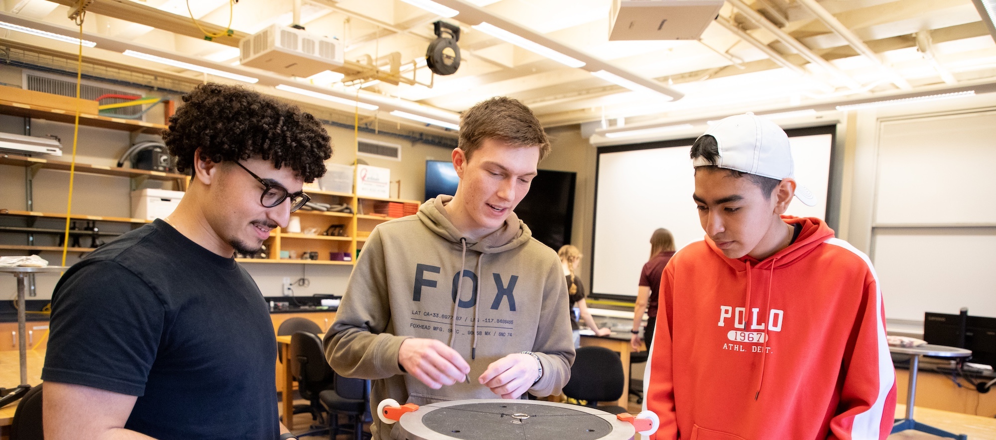 three mpc students working on project together