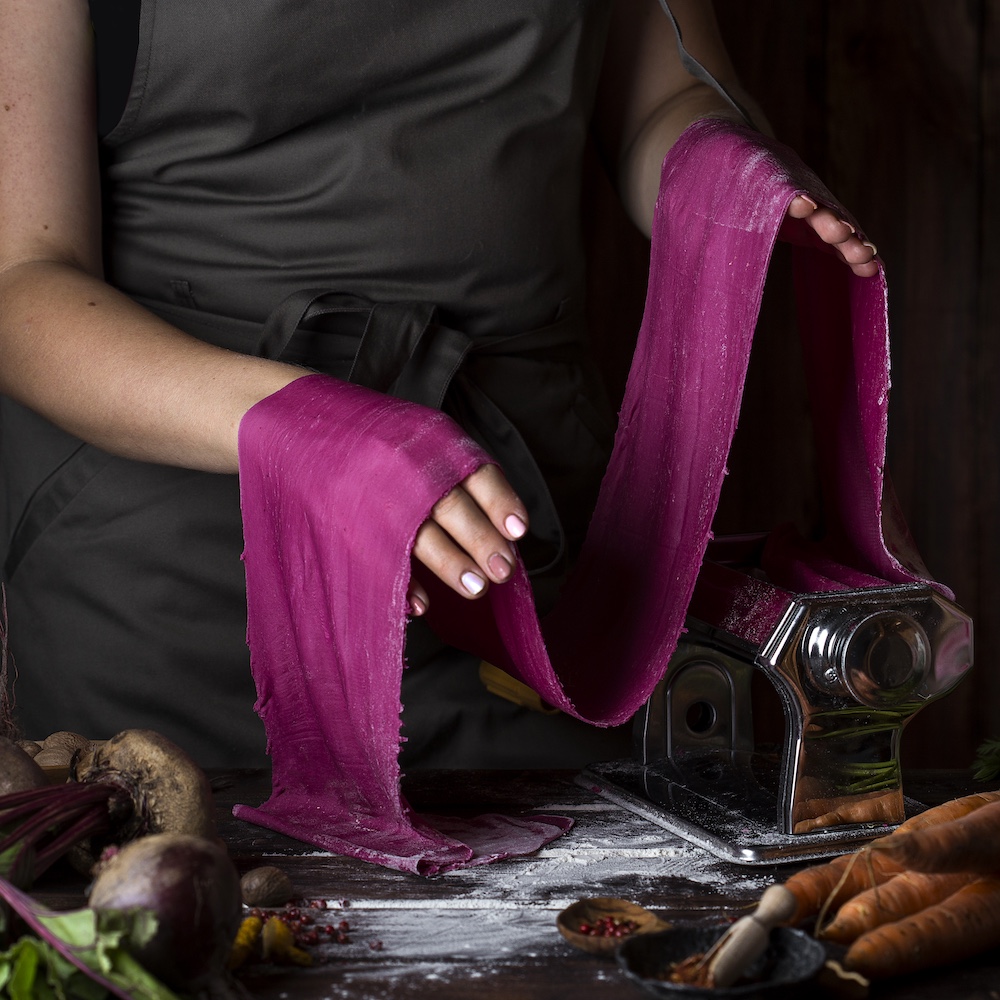 Culinary Artist Rolling Out Purple Pasta Dough