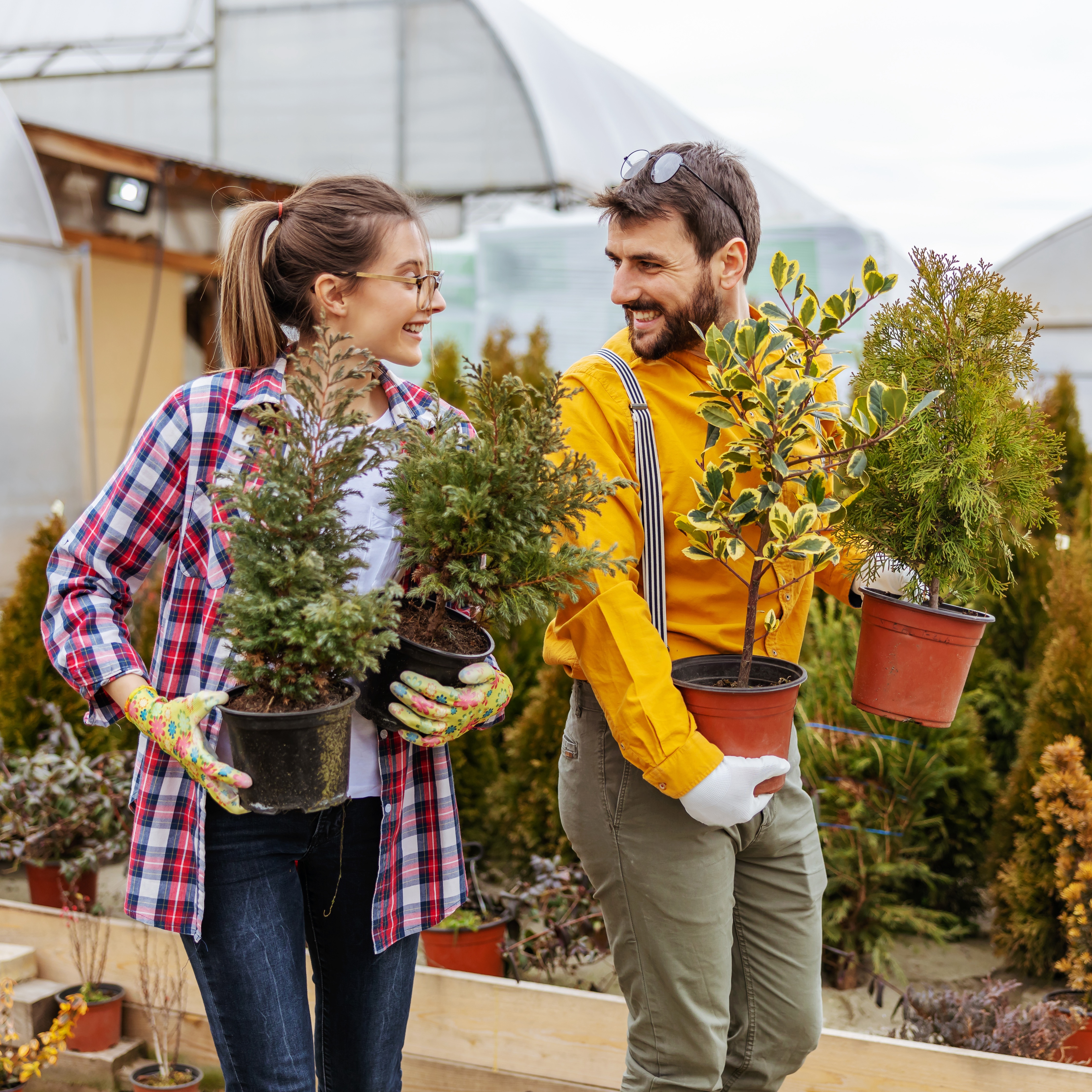 Two Horticulturists Holding Plants