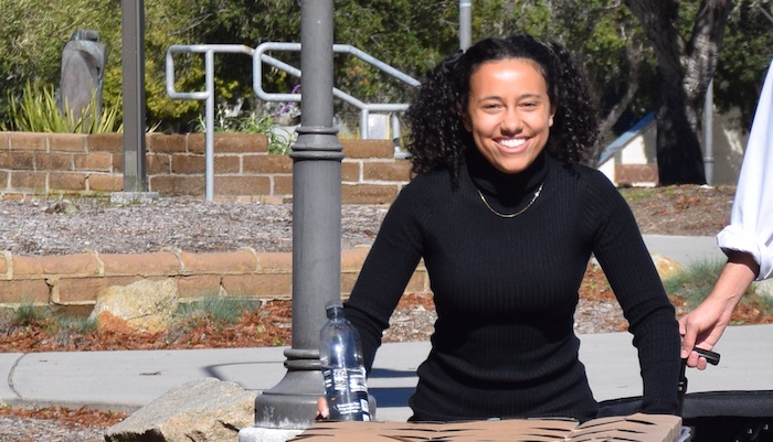mpc student pushing cart across campus