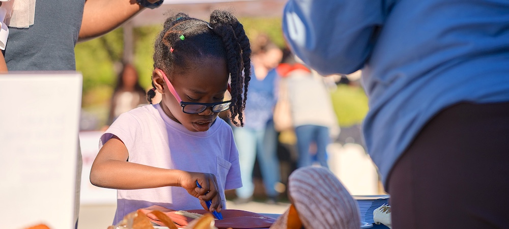 Child Participating in Family STEM Day