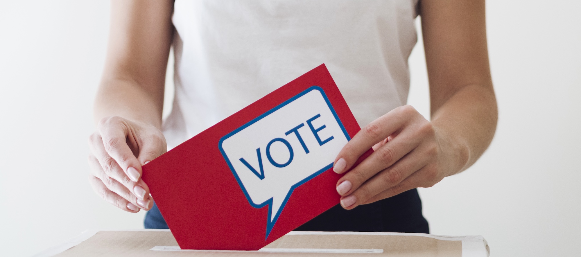 Woman Placing Voter Ballot into Box