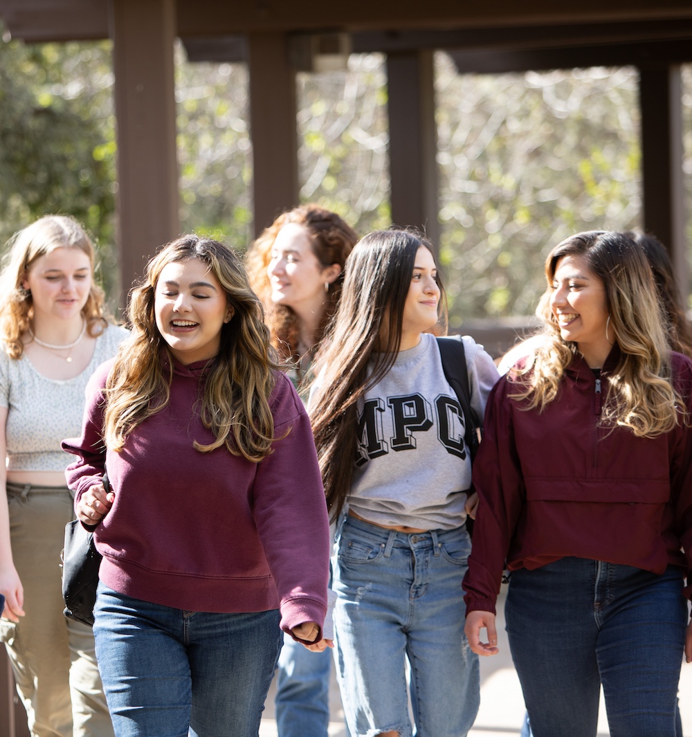 Students Talking & Walking Outdoors in a Group