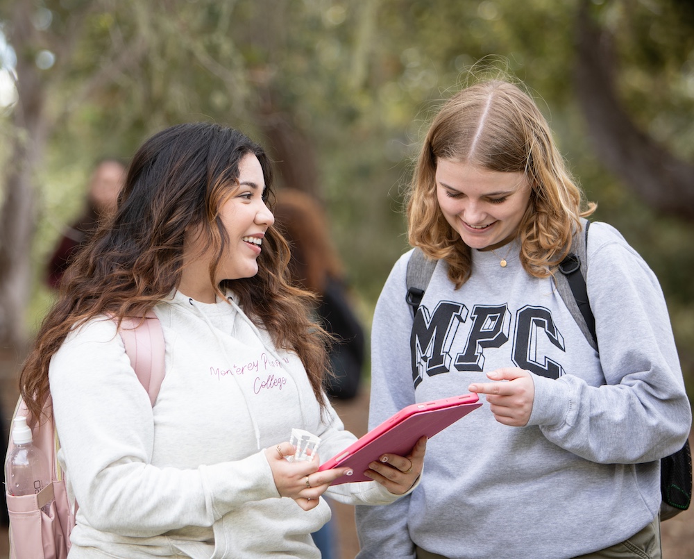 Two Students Discussing Over Tablet