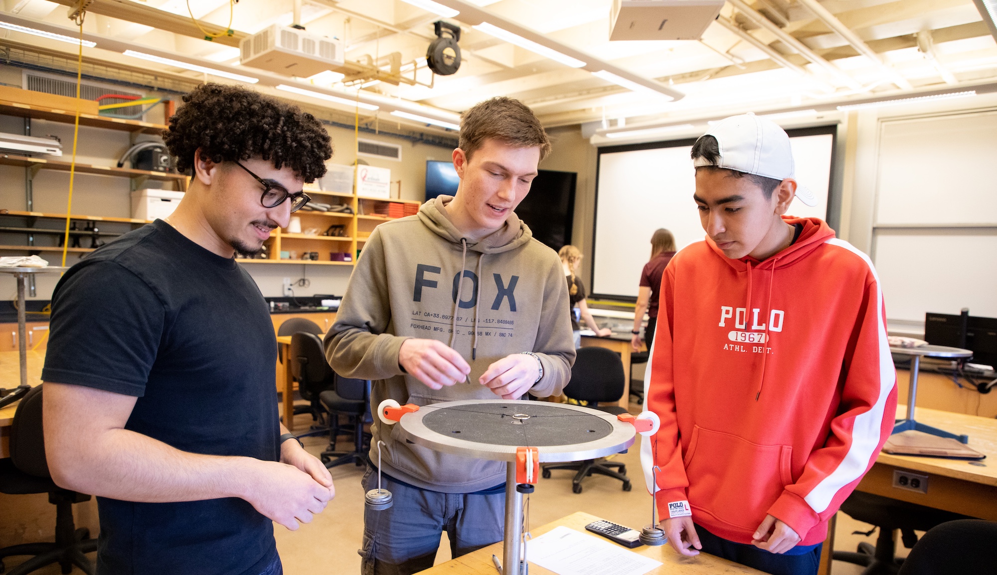 three mpc students working on project together