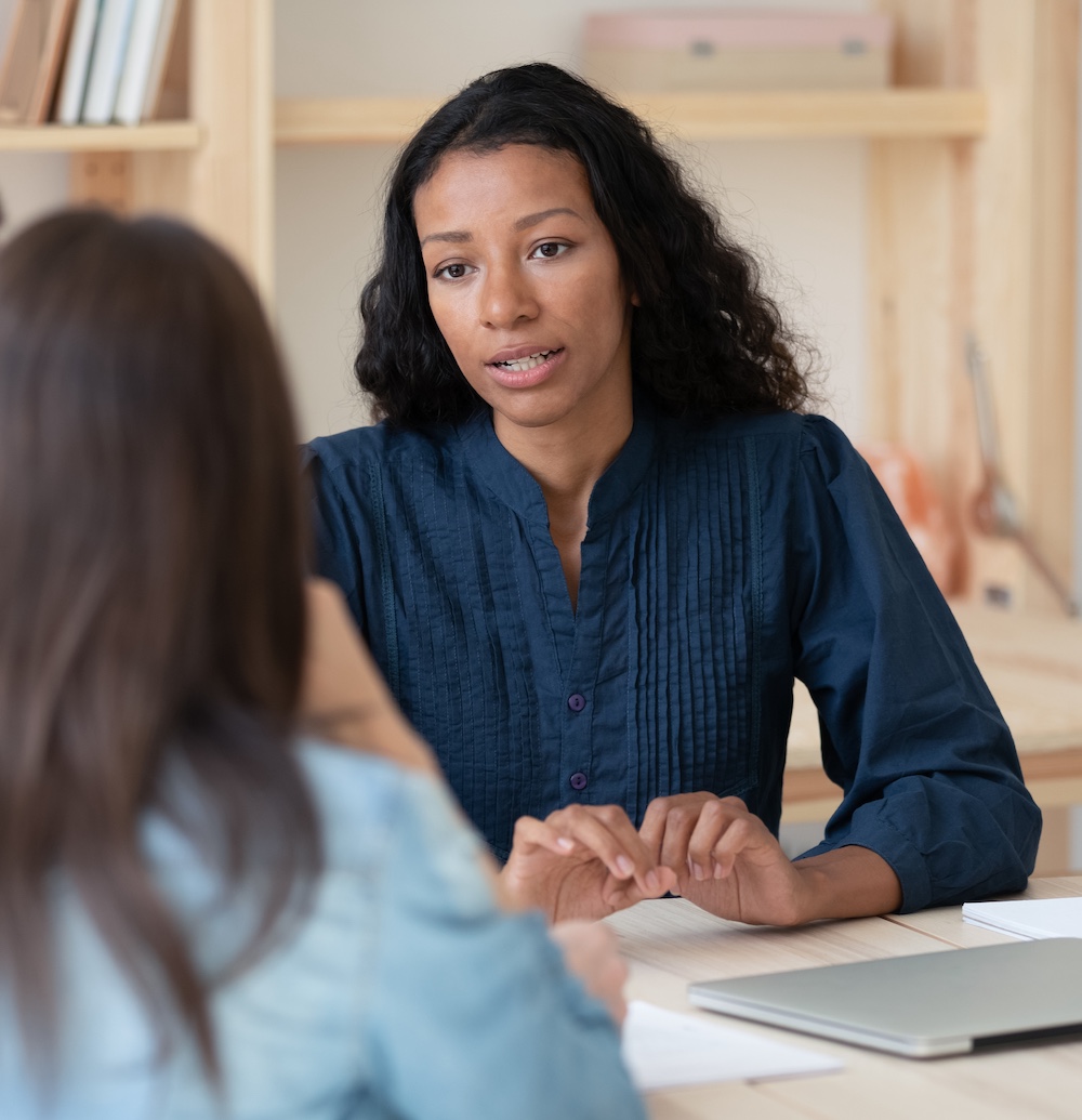 Woman Counselor Speaking with Student