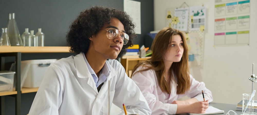 Two Students Listening in Science Class