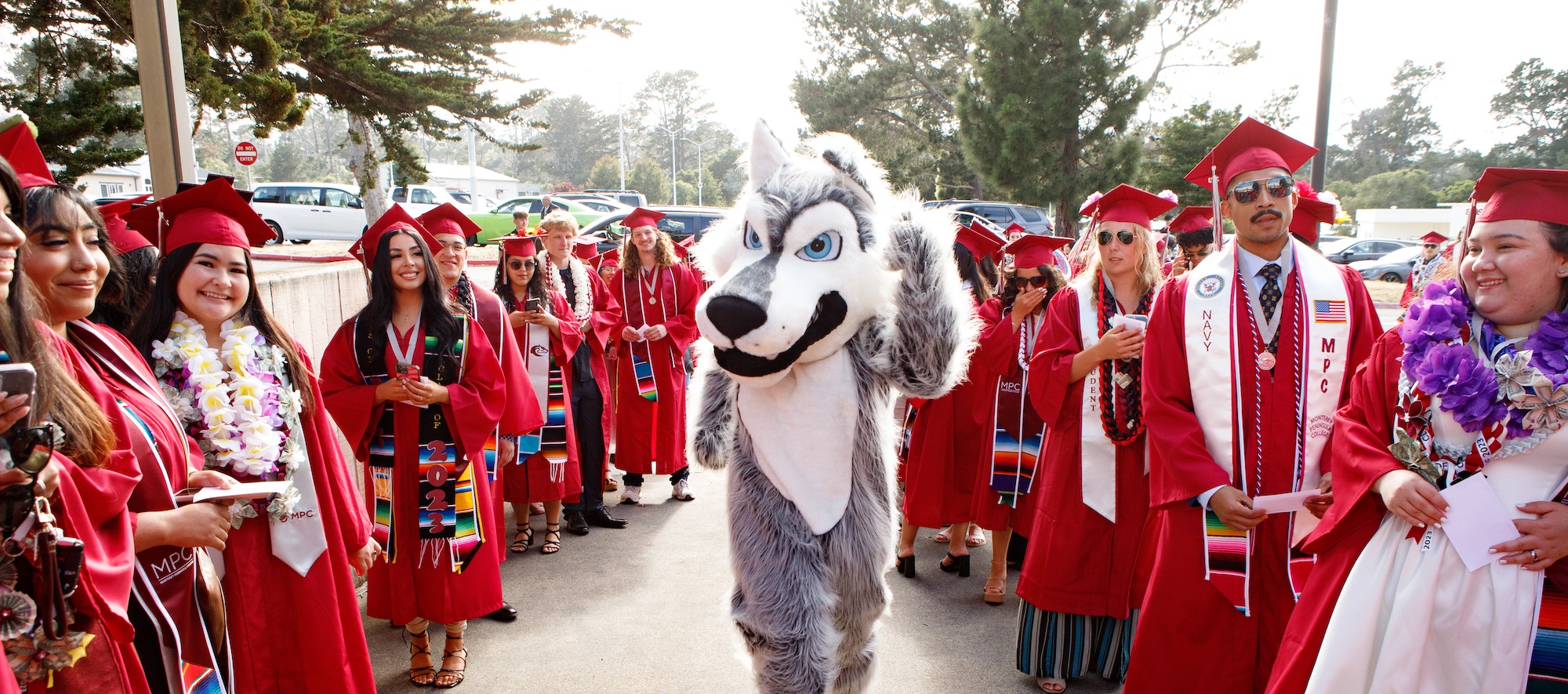 Students Smiling and Walking in Regalia at MPC Graduation